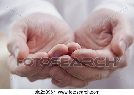Stock Photo - Cupped hands of Hispanic doctor. Fotosearch