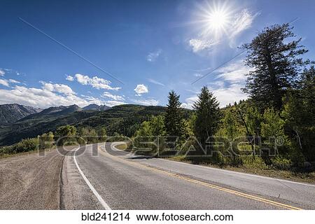 Curving two-lane road near mountains View Large Photo Image Picture - Curving two-lane road near mountains. Fotosearch