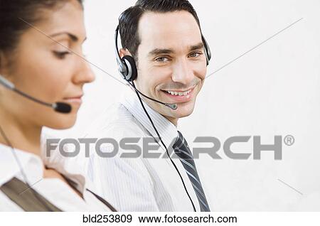 Customer service representatives wearing headsets View Large Photo Image Stock Photo - Customer service representatives wearing headsets. Fotosearch