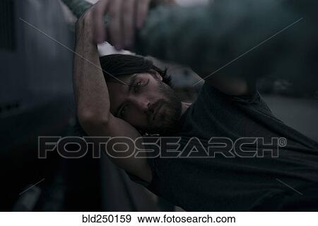 Depressed Caucasian man holding thick rope View Large Photo Image Stock Photo - Depressed Caucasian man holding thick rope. Fotosearch