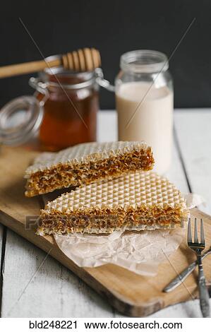Dessert on cutting board with milk and honey View Large Photo Image Stock Image - Dessert on cutting board with milk and honey. Fotosearch