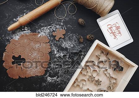 Picture - "Digital tablet, gingerbread dough and pastry cutters". Fotosearch