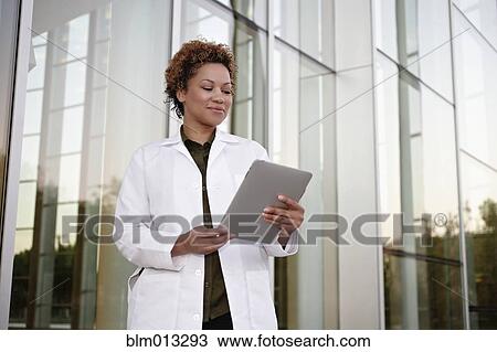 Stock Image - Doctor using digital tablet. Fotosearch