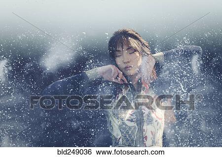 Droplets splashing near woman View Large Photo Image Stock Photograph - Droplets splashing near woman. Fotosearch