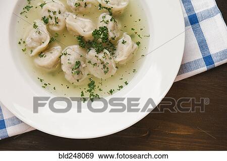 Stock Photo - Dumplings in bowl of soup. Fotosearch