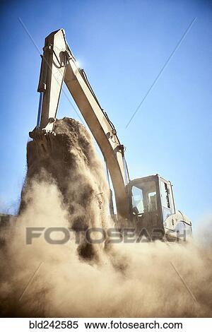 Dust from digger digging dirt View Large Photo Image Stock Photography - Dust from digger digging dirt. Fotosearch