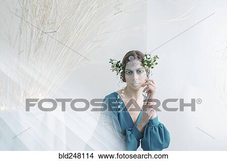 Picture - Ethereal woman wearing blue dress and makeup. Fotosearch
