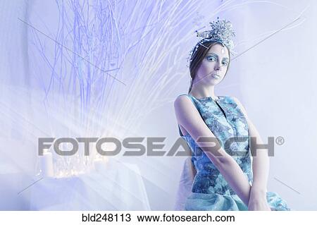 Stock Image - Ethereal woman wearing blue dress and makeup. Fotosearch