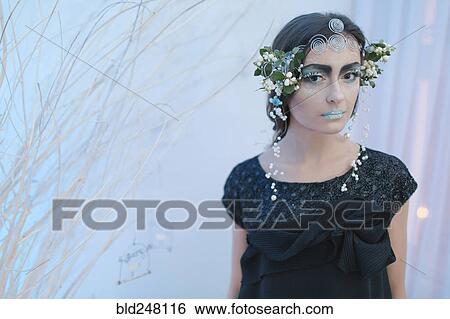 Stock Photograph - Ethereal woman wearing dress and makeup. Fotosearch