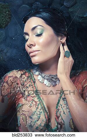 Exotic Hispanic woman laying in water View Large Photo Image Stock Image - Exotic Hispanic woman laying in water. Fotosearch