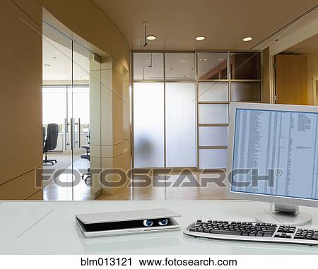 Eyes peering out of laptop on office desk View Large Photo Image Stock Image - Eyes peering out of laptop on office desk. Fotosearch