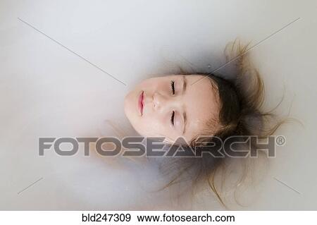 Face of Caucasian girl floating in bathtub View Large Photo Image Stock Photo - Face of Caucasian girl floating in bathtub. Fotosearch