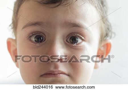 Stock Photograph - Face of Hispanic boy crying. Fotosearch