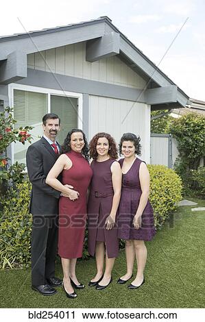 Family posing near house View Large Photo Image Stock Image - Family posing near house. Fotosearch