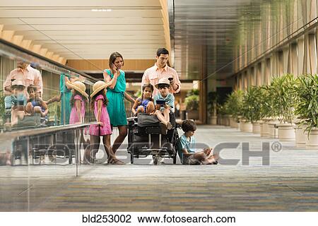 Family waiting in airport using cell phones View Large Photo Image Stock Image - Family waiting in airport using cell phones. Fotosearch