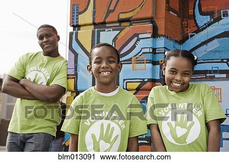 Stock Image - Father and children volunteering. Fotosearch