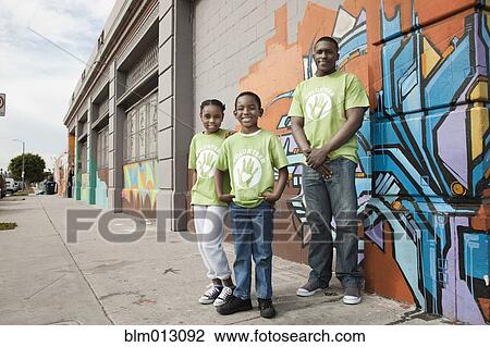 Stock Image - Father and children volunteering. Fotosearch