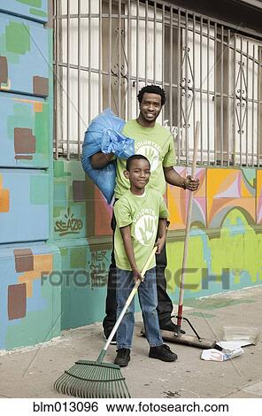 Stock Photograph - Father and son picking up litter. Fotosearch