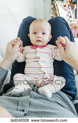 Father playing with baby daughter in lap View Large Photo Image Stock Photo - Father playing with baby daughter in lap. Fotosearch