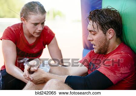 Fatigued Caucasian man and woman resting outdoors View Large Photo Image Stock Photography - Fatigued Caucasian man and woman resting outdoors. Fotosearch