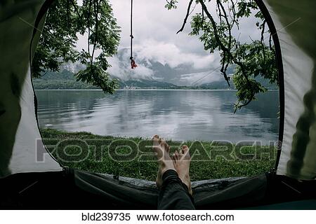 Feet on man laying in camping tent at lake View Large Photo Image Stock Photography - Feet on man laying in camping tent at lake. Fotosearch