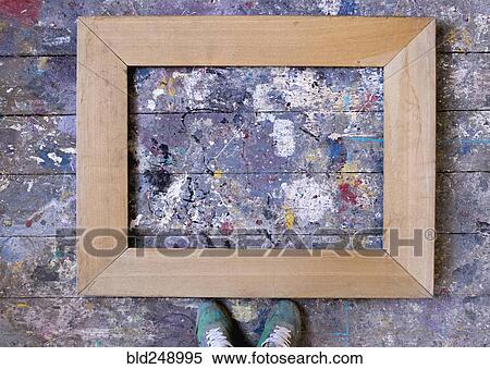 Feet standing over picture frame on wooden floor View Large Photo Image Stock Photography - Feet standing over picture frame on wooden floor. Fotosearch