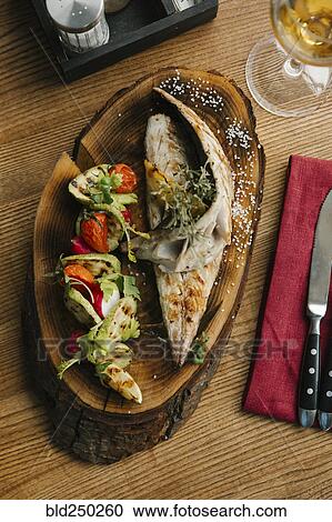 Stock Image - Fish and vegetables with white wine. Fotosearch