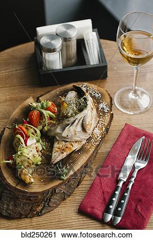 Stock Image - Fish and vegetables with white wine. Fotosearch