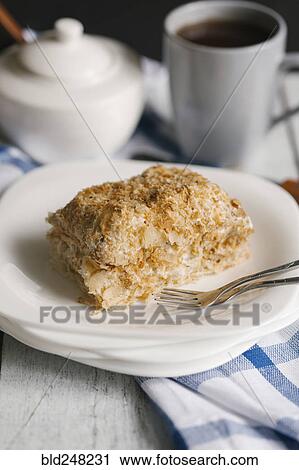 Stock Image - Flaky pastry on a plate with coffee. Fotosearch
