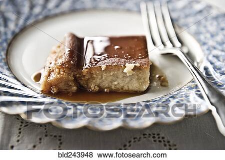 Stock Photo - Flan on plate with syrup and fork. Fotosearch