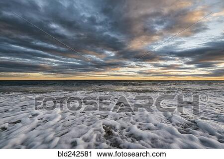Foam in waves on ocean beach View Large Photo Image Stock Image - Foam in waves on ocean beach. Fotosearch