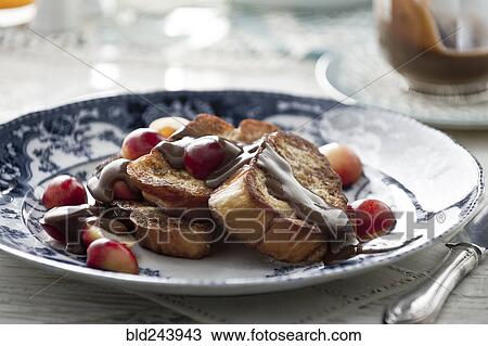 Stock Image - French toast with syrup and cherries. Fotosearch