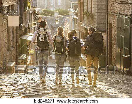 Stock Image - Friends backpacking in city. Fotosearch