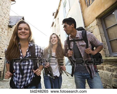 Stock Photography - Friends backpacking in city. Fotosearch