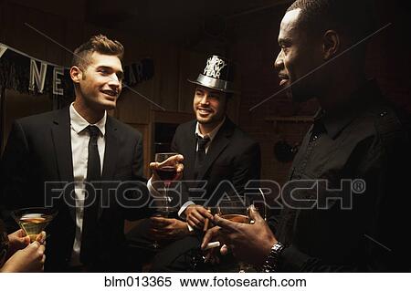 Friends drinking in kitchen at New Year's Eve party View Large Photo Image Stock Photography - Friends drinking in kitchen at New Year's Eve party. Fotosearch