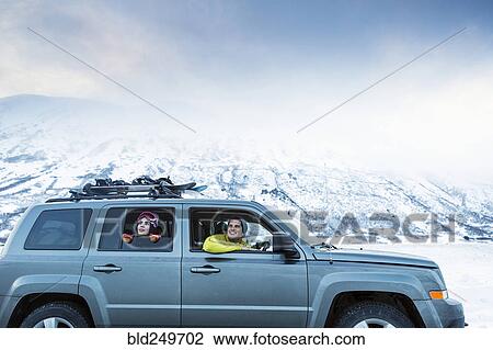 Friends enjoying scenic view from car in winter View Large Photo Image Stock Image - Friends enjoying scenic view from car in winter. Fotosearch