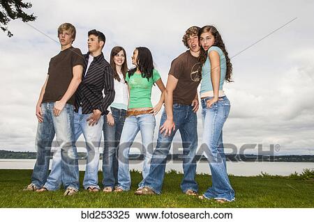 Stock Photography - Friends posing near lake. Fotosearch