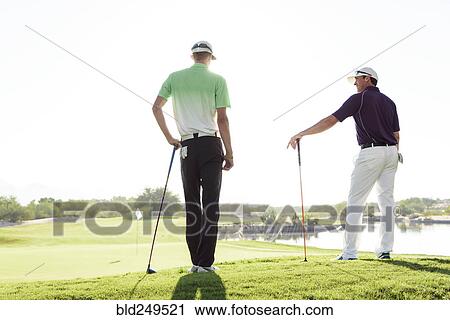 Friends talking on golf course View Large Photo Image Stock Image - Friends talking on golf course. Fotosearch