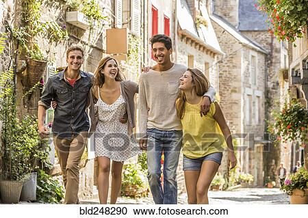 Friends walking in city View Large Photo Image Stock Image - Friends walking in city. Fotosearch