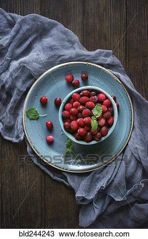 Frozen red berries on wooden table View Large Photo Image Stock Image - Frozen red berries on wooden table. Fotosearch
