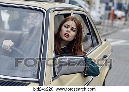 Frustrated Caucasian woman leaning on door driving car View Large Photo Image Stock Image - Frustrated Caucasian woman leaning on door driving car. Fotosearch