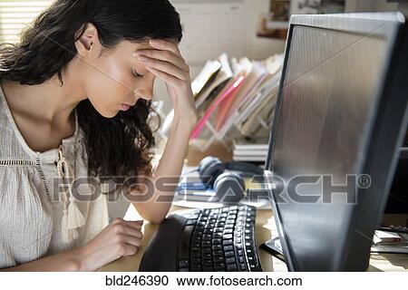 Frustrated Hispanic woman using computer View Large Photo Image Stock Image - Frustrated Hispanic woman using computer. Fotosearch