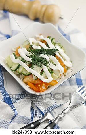 Garnish and dressing on salad in bowl View Large Photo Image Stock Photo - Garnish and dressing on salad in bowl. Fotosearch