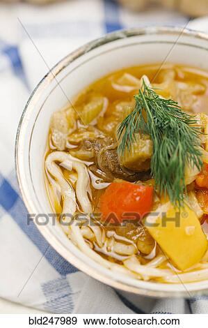 Stock Photo - Garnish on bowl of soup with noodles. Fotosearch