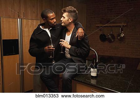 Gay couple drinking wine in kitchen View Large Photo Image Stock Image - Gay couple drinking wine in kitchen. Fotosearch