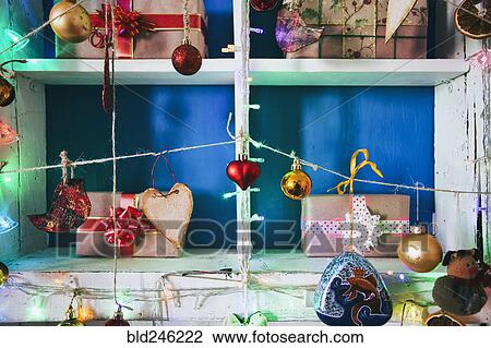 Gift boxes on wooden shelves near ornaments View Large Photo Image Stock Image - Gift boxes on wooden shelves near ornaments. Fotosearch