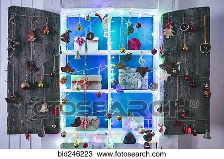 Stock Image - Gift boxes on wooden shelves near ornaments. Fotosearch