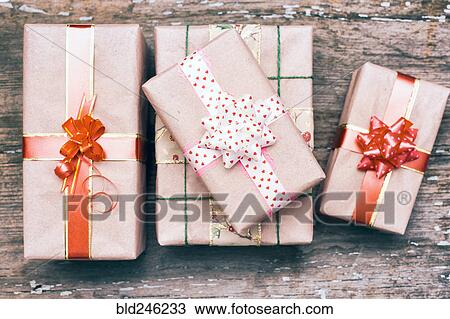 Stock Image - Gift boxes on wooden table. Fotosearch