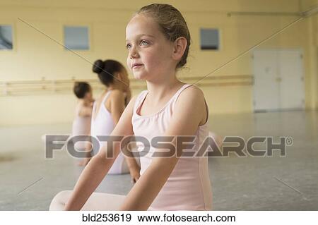 Stock Photo - Girl sitting on floor of ballet studio. Fotosearch