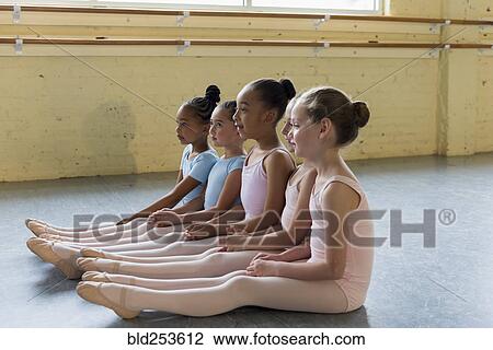 Girls sitting in a row on floor of ballet studio View Large Photo Image Stock Image - Girls sitting in a row on floor of ballet studio. Fotosearch